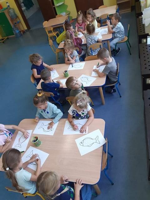 dzieci rysują przy stolikach